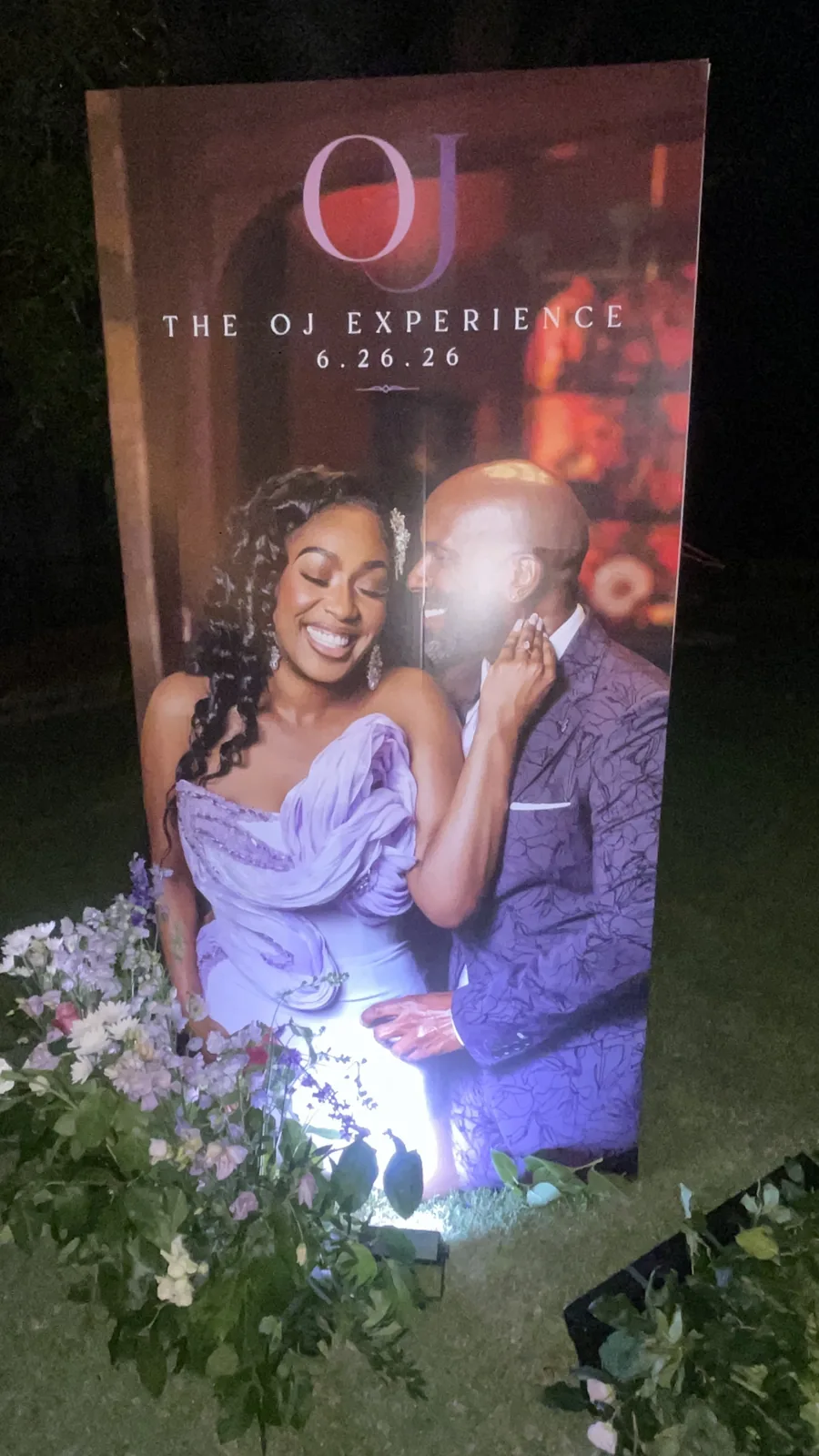 A large custom photo board of the couple in purple at The OJ Experience wedding