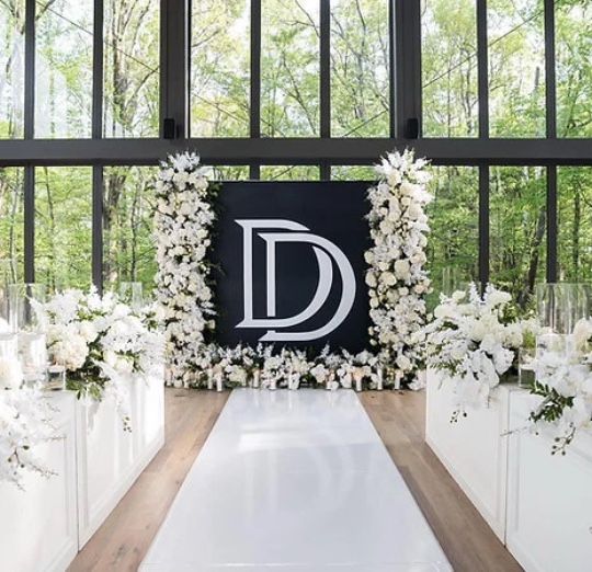 A custom photo board styled at a wedding reception
