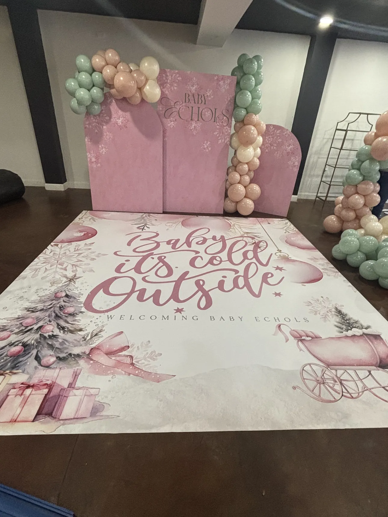 A pink Baby It's Cold Outside dance floor wrap for a winter baby shower