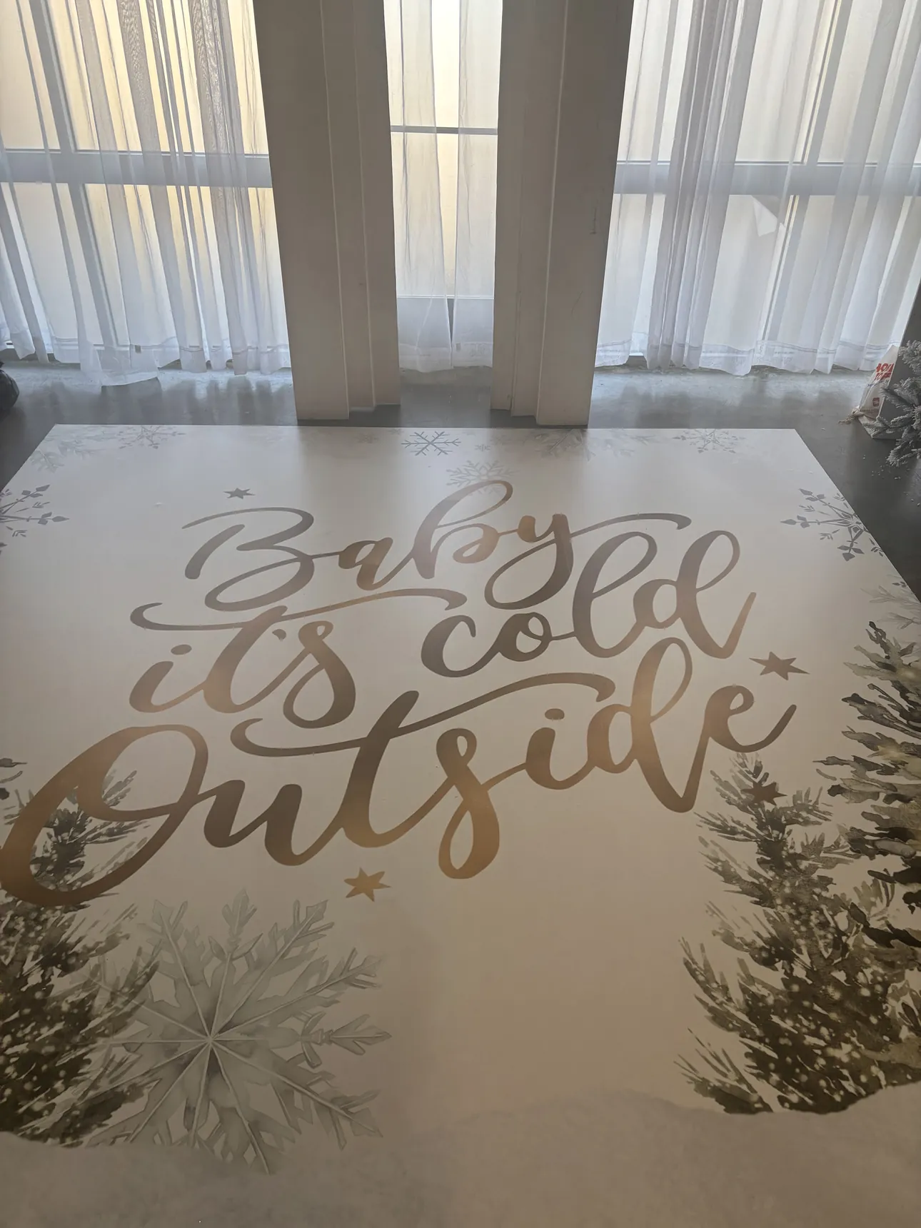 A close view of a gold script baby shower dance floor wrap