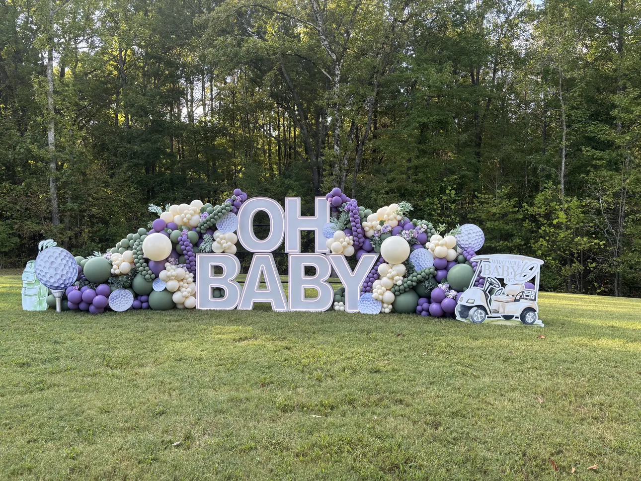 Large Oh Baby yard letters set up on a lawn for an outdoor baby shower