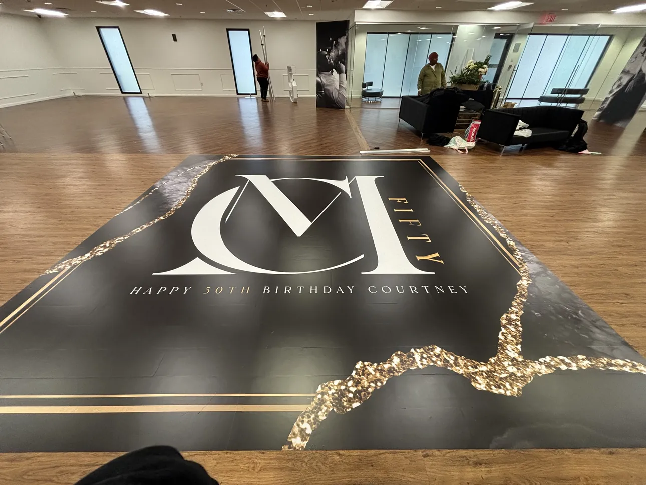 A black and gold monogram dance floor wrap for a 50th birthday