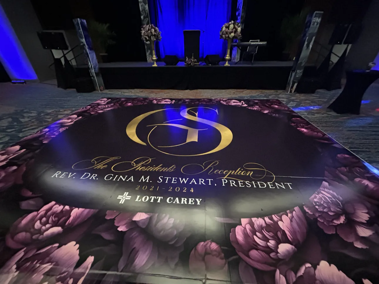 A wide view of The President's Reception floor wrap in a lit ballroom