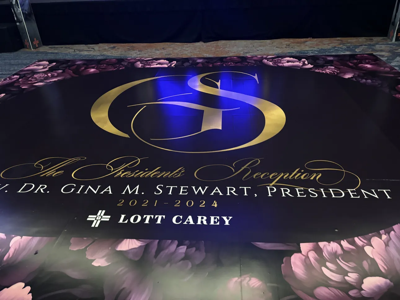 A purple and gold floor wrap for The President's Reception honoring Rev. Dr. Gina M. Stewart