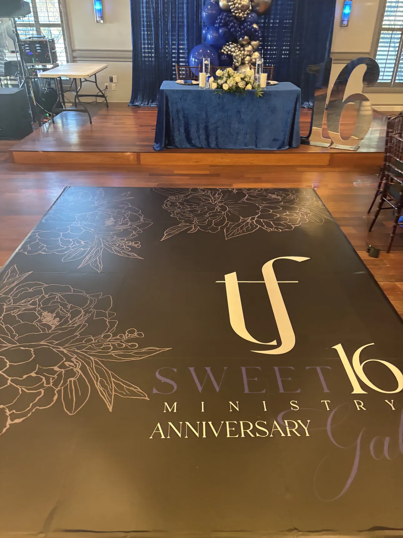 A black and gold floor wrap for a Sweet 16 Ministry Anniversary Gala