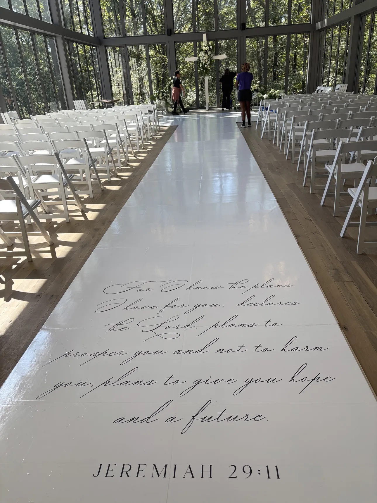 A white aisle runner printed with Jeremiah 29:11