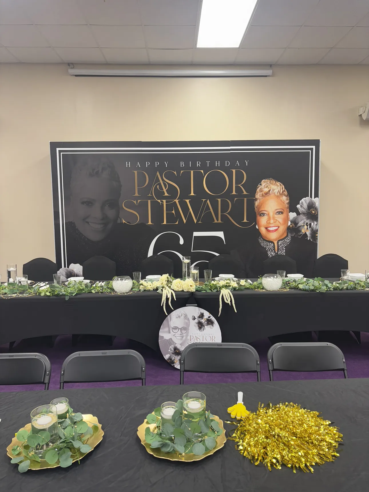 A Happy Birthday Pastor Steward 65 backdrop behind the head table
