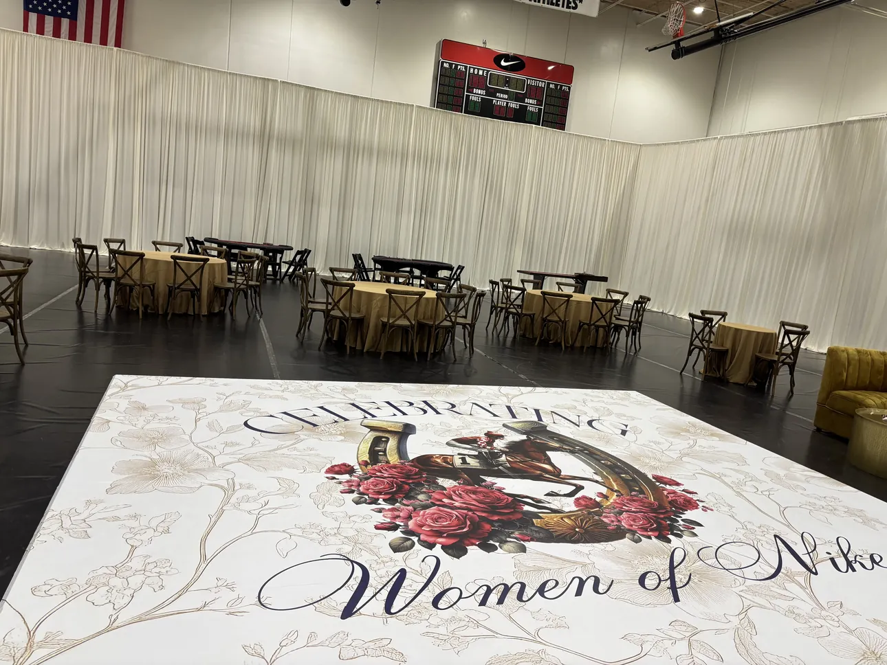 A floral Celebrating Women of Nike floor wrap in an event hall