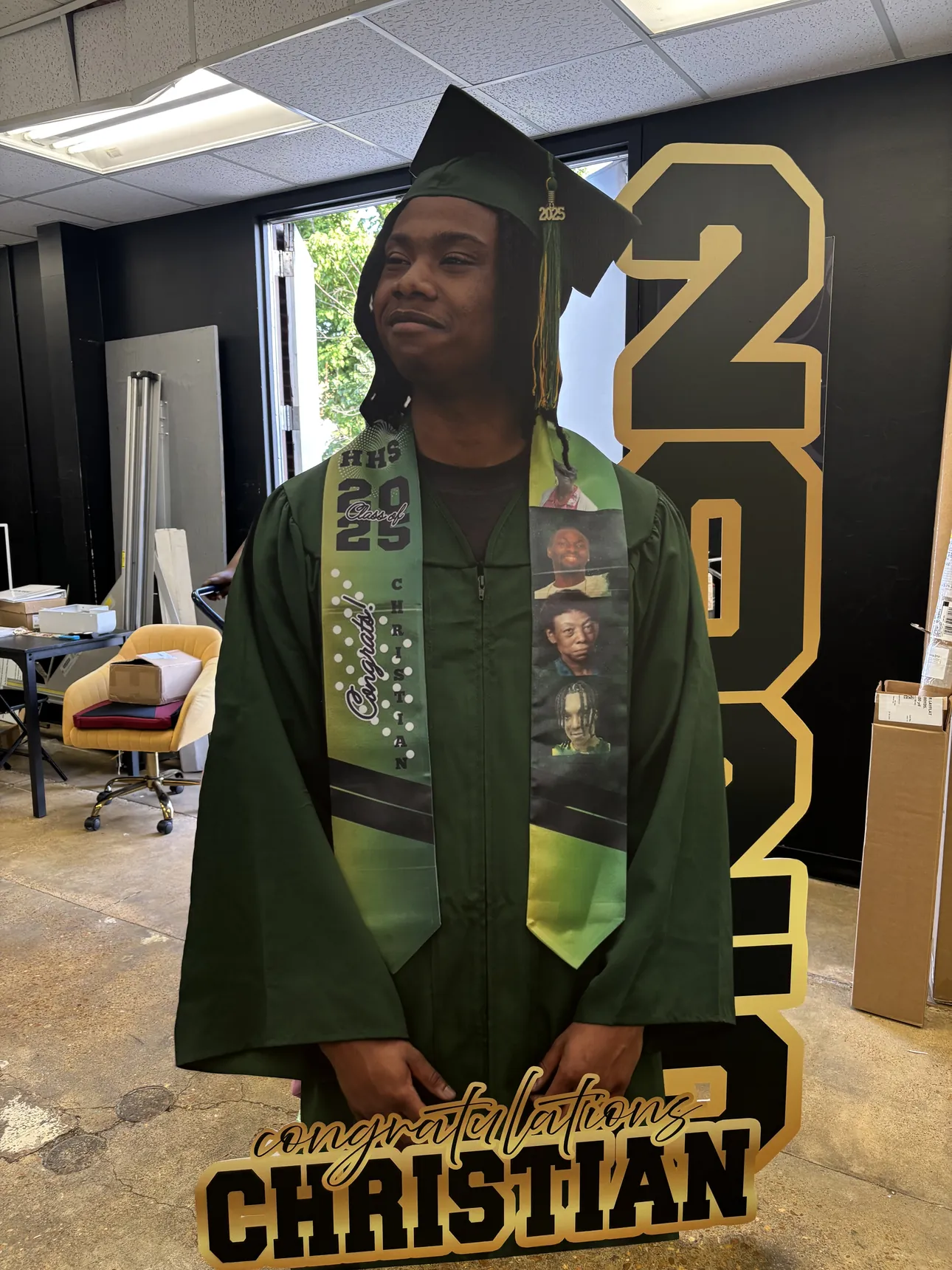 A front view of a custom graduation cutout with a gold 2025 behind the graduate